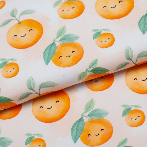 Tissu en ligne jersey de coton lycra motif de clémentine kawaii. Online fabric cotton spandex jersey knit with kawaii orange.
