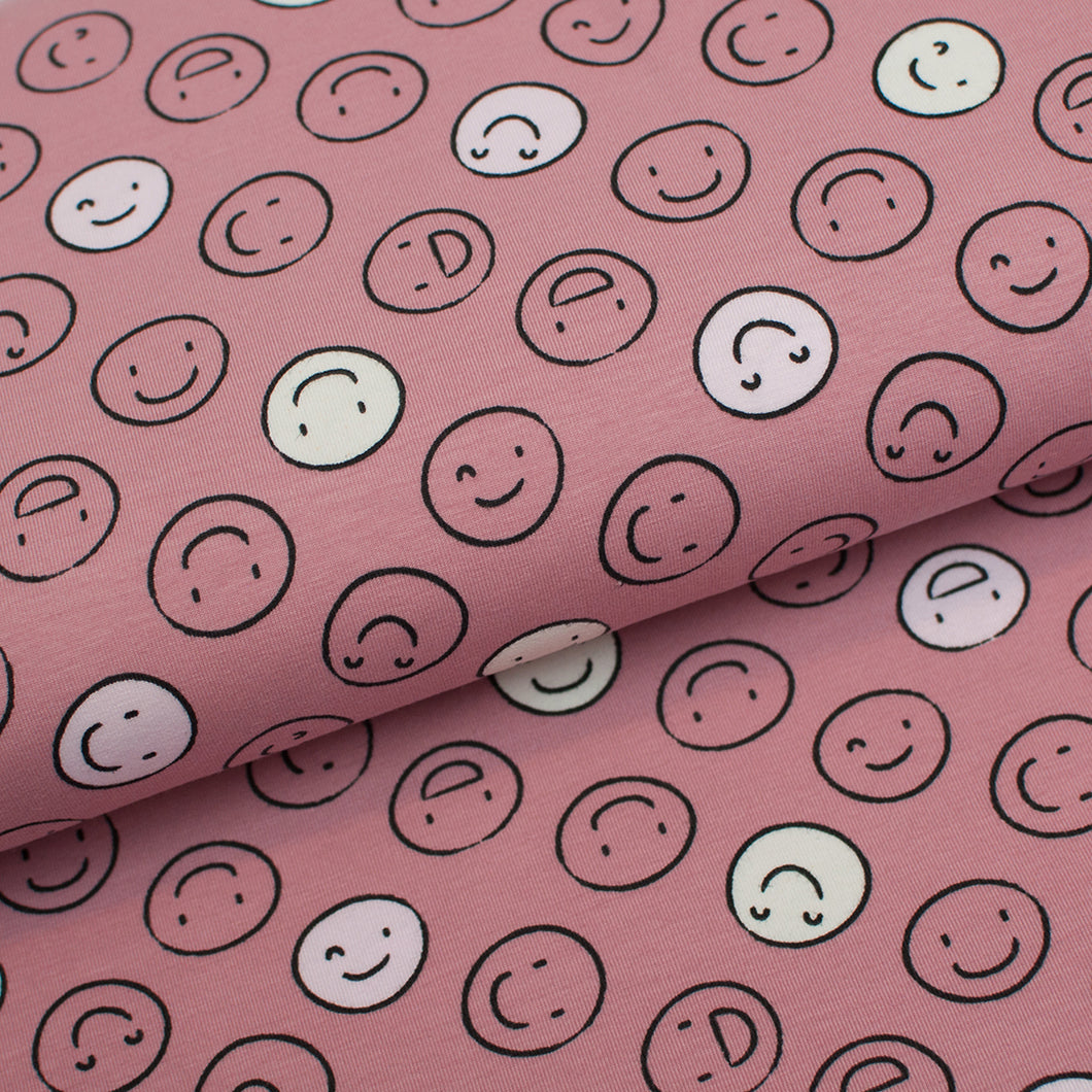 Tissu en ligne Québec jersey de coton lycra motif de smiley qui allument dans le noir. Online fabric cotton spandex jersey knit glow in the dark with smileys.
