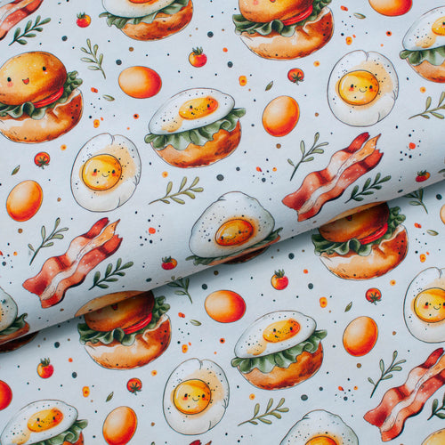 Tissu en ligne Québec jersey de coton lycra motif de déjeuner oeuf bacon. Online fabric store cotton spandex jersey knit with breakfast eggs and bacon.