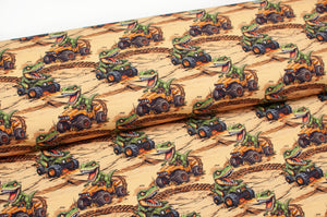 Tissu en ligne Québec jersey de coton lycra motif de dinosaure en quatre roue. Online Canadian fabric store cotton spandex jersey knit with dinosaur doing four wheels.